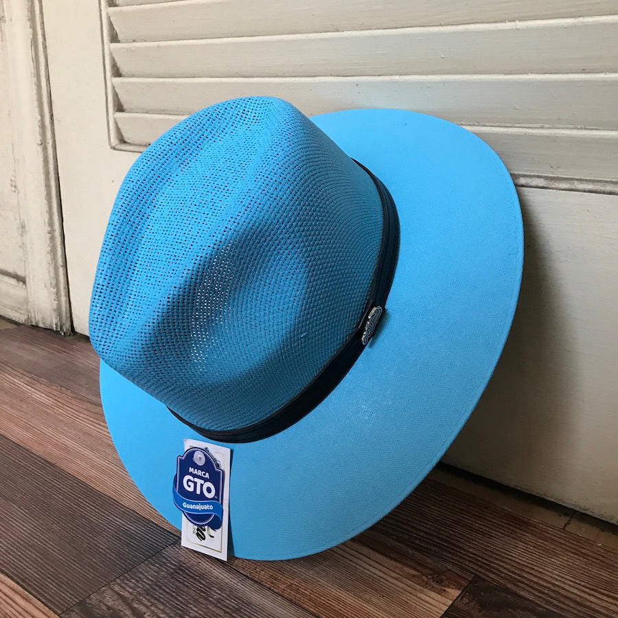 A medium-sized baby blue straw hat with a leather band, made of palm straw, displayed on a wooden surface.