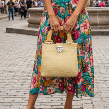 Woman in a floral dress standing on a street in a colorful, European-style town.